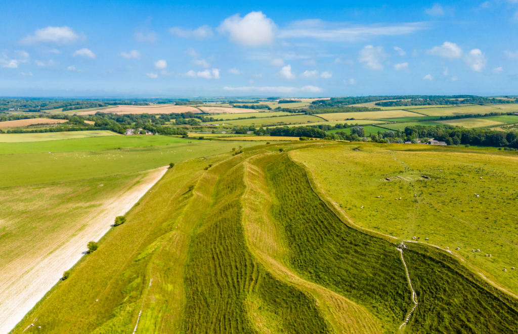 Ancient hill fort at Maiden Castle showcasing West Dorset’s early history near Blackbird Cottage.